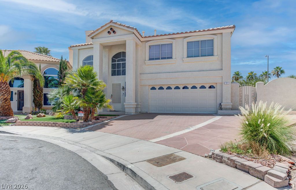 1 Rising Sun Court Henderson, NV 89074 - Photo 46 of 47 Architectural columns and arched windows highlight this striking home with a paver driveway.