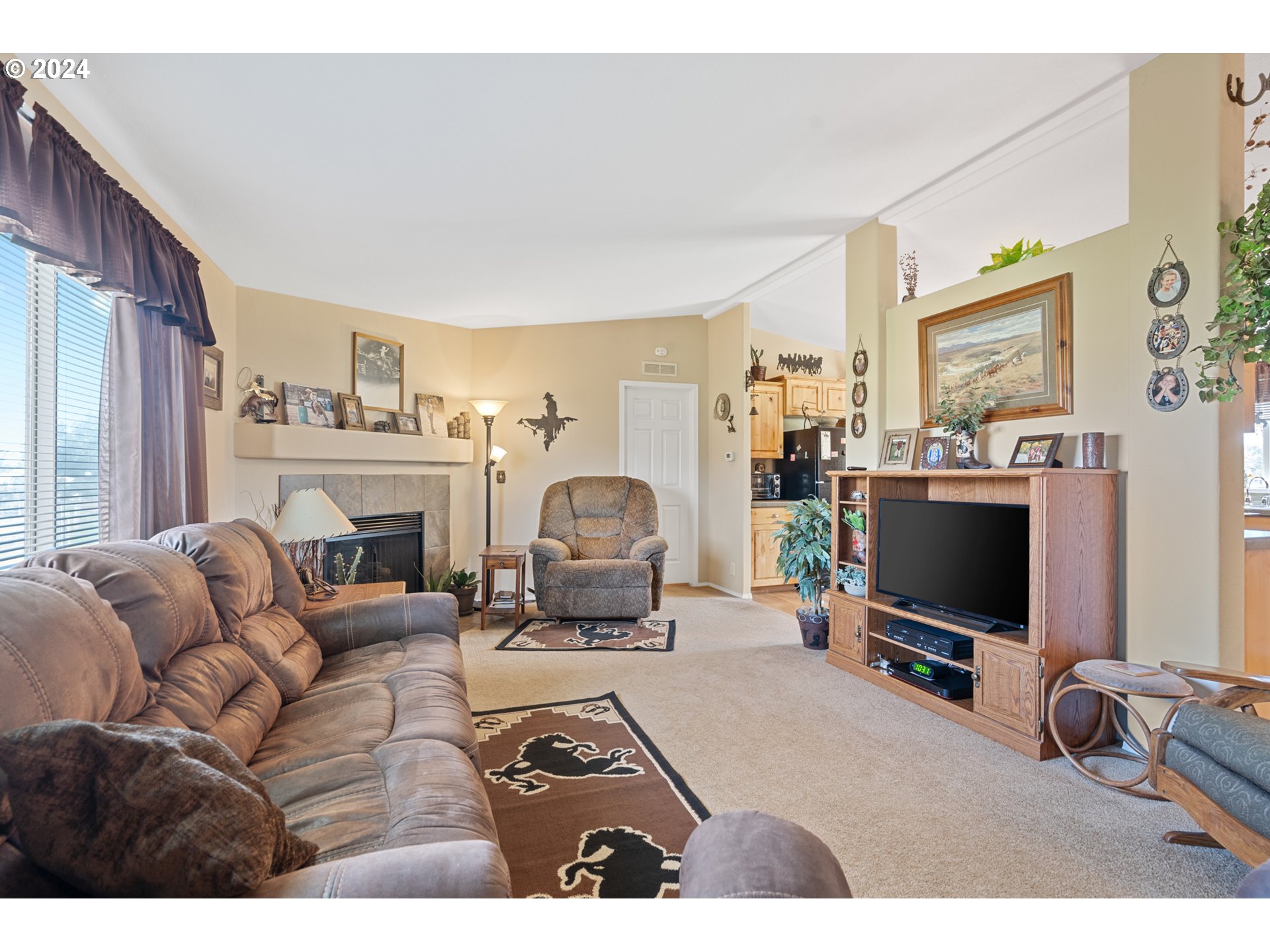81385 North Golda Road Hermiston, OR 97838 - Photo 5 of 40 a living room with furniture a flat screen tv and a fireplace