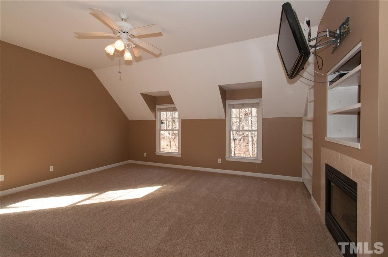 13423 Melvin Arnold Road Raleigh, NC 27613 - Photo 15 of 25 Spacious master suite with see thru gas log fireplace, sitting room, whirlpool bath and walk-in closet Master Bedroom