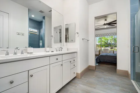 a en suite bathroom with a double vanity sink and a mirror