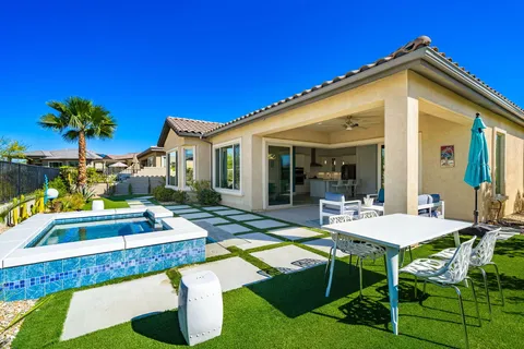 a view of a house with swimming pool and sitting area