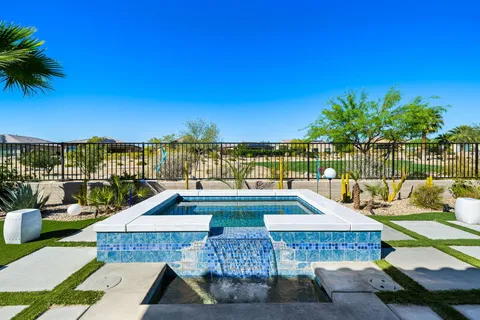 a view of a swimming pool with a lounge chair