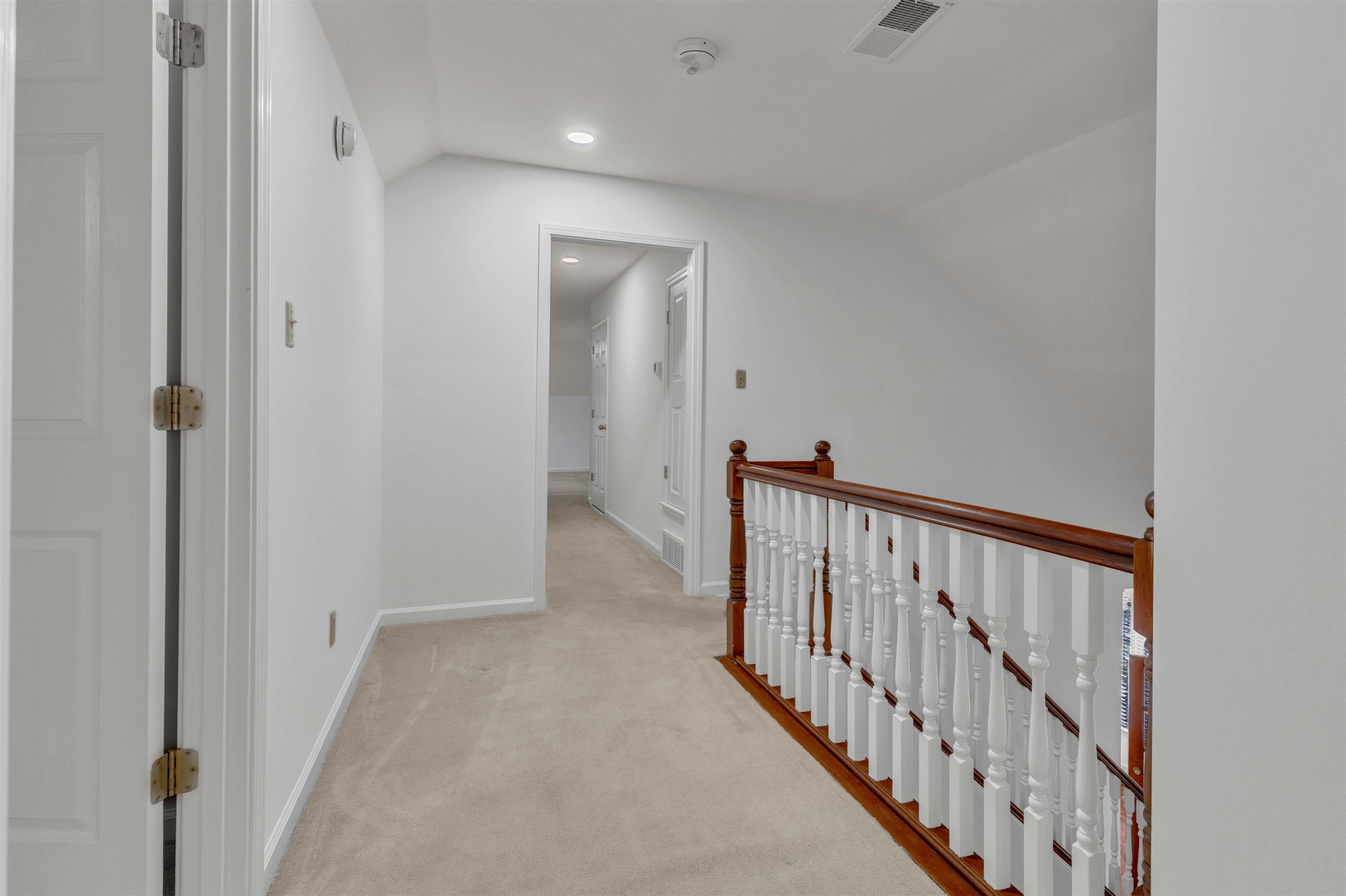 917 Valleyview Lane Collierville, TN 38017 - Photo 11 of 35 Hallway with light colored carpet, an upstairs landing, lofted ceiling, and recessed lighting
