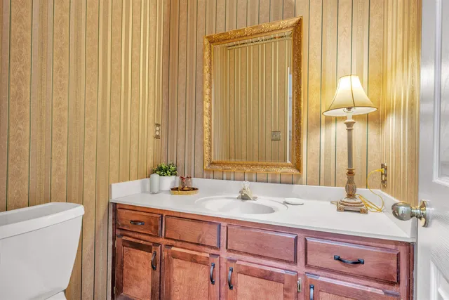 a living room with furniture a flat screen tv and a floor to ceiling window
