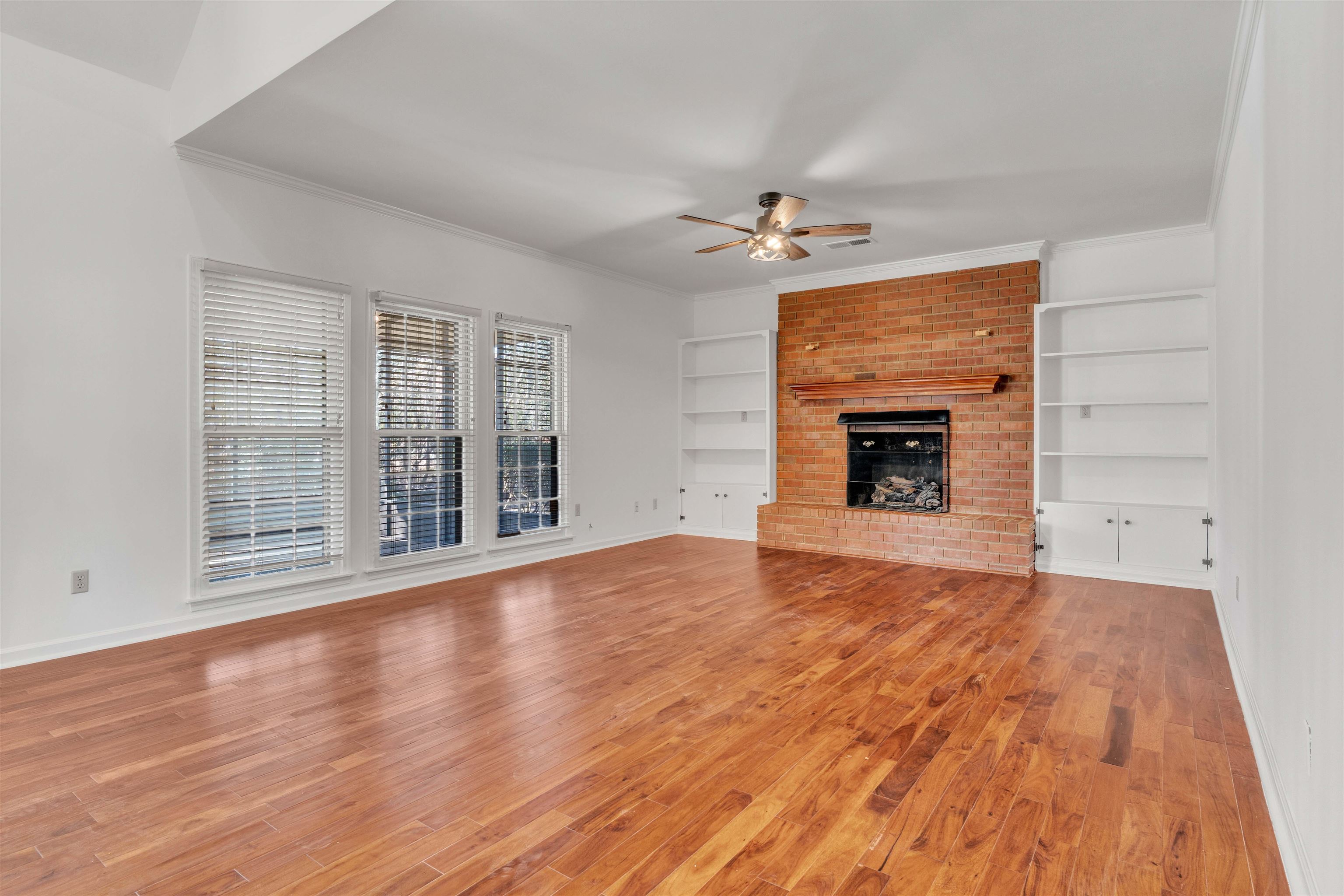 917 Valleyview Lane Collierville, TN 38017 - Photo 31 of 35 wooden floor fireplace and natural light in room