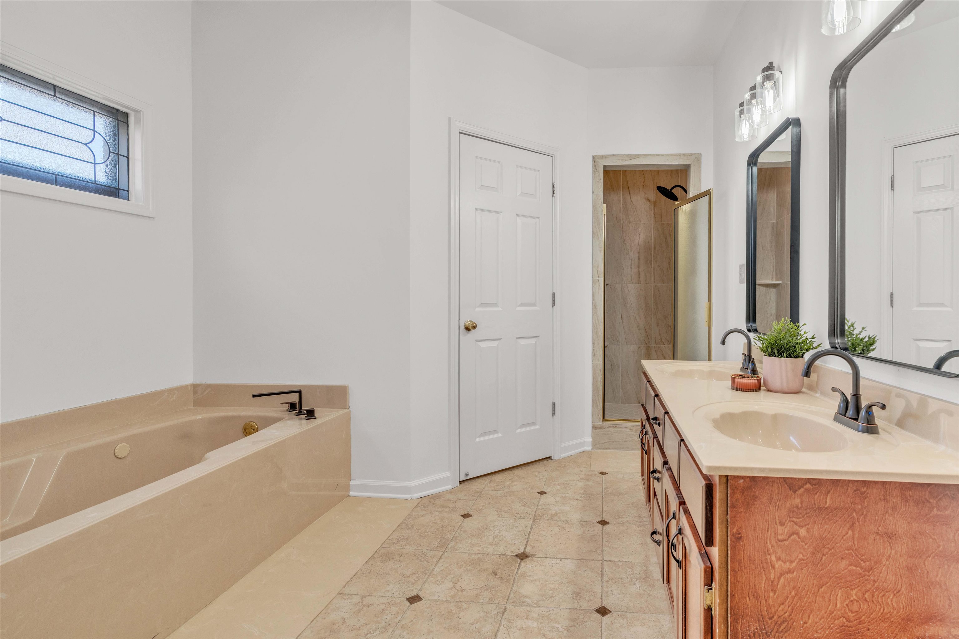 917 Valleyview Lane Collierville, TN 38017 - Photo 5 of 35 Bathroom with double vanity, a bath, a stall shower, and light tile patterned floors