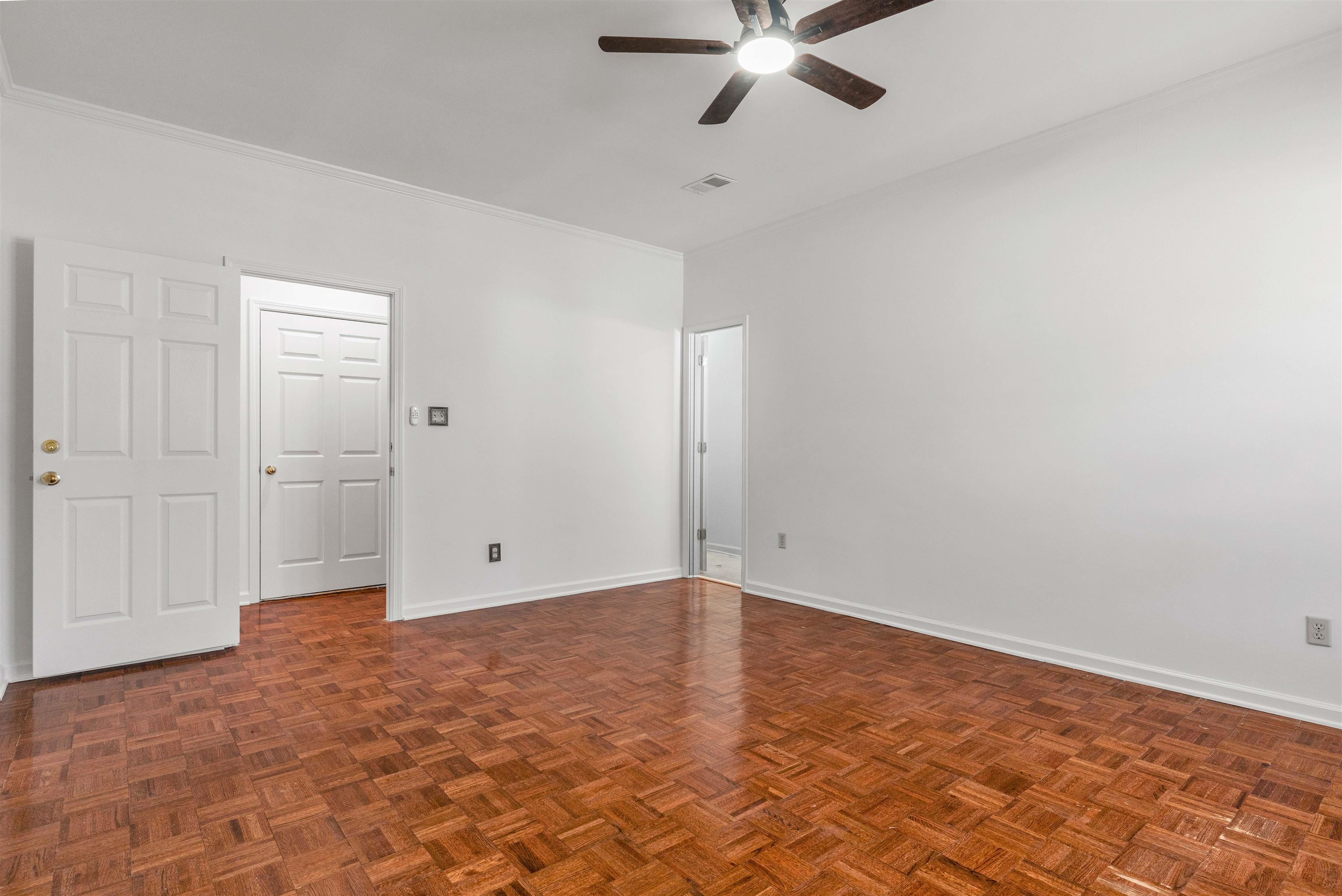 917 Valleyview Lane Collierville, TN 38017 - Photo 7 of 35 Spare room with parquet floors, a ceiling fan, and crown molding