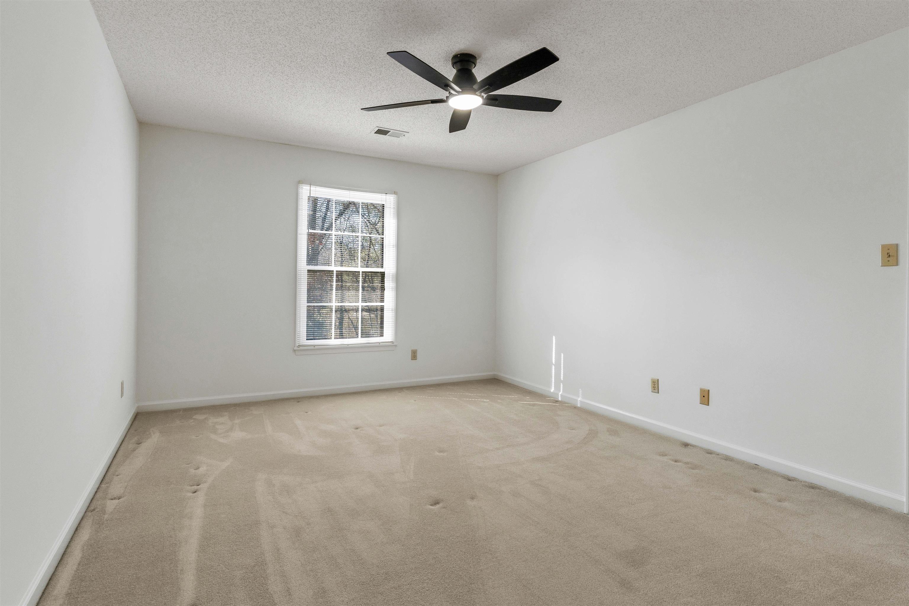 917 Valleyview Lane Collierville, TN 38017 - Photo 10 of 35 an empty room with ceiling fan and window