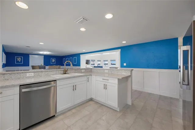 a view of kitchen with white cabinets