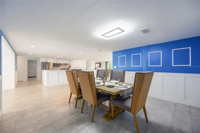 a dining room with furniture and window