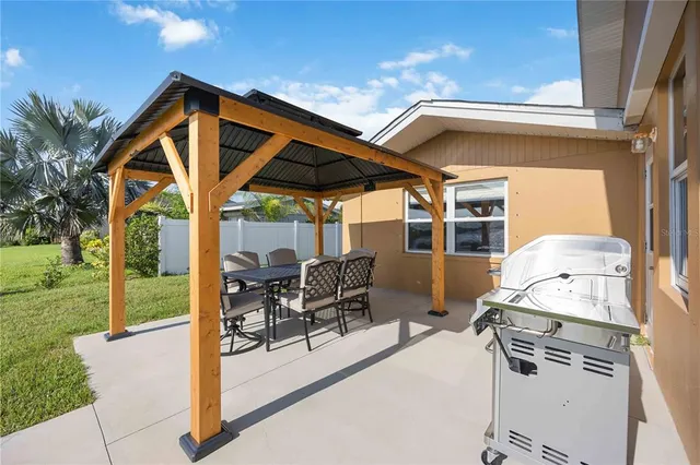 a view of a patio with a table and chairs