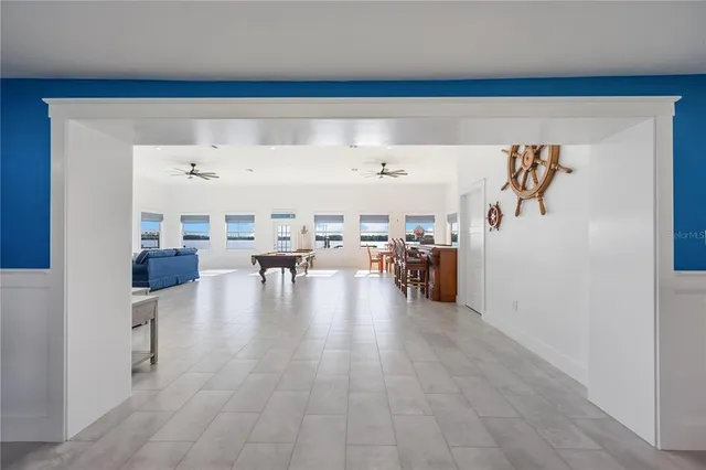 a living room with furniture and a view of kitchen