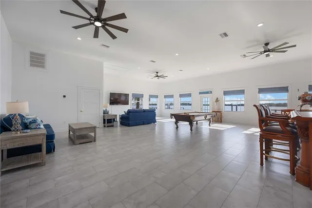 a living room with furniture and a ceiling fan