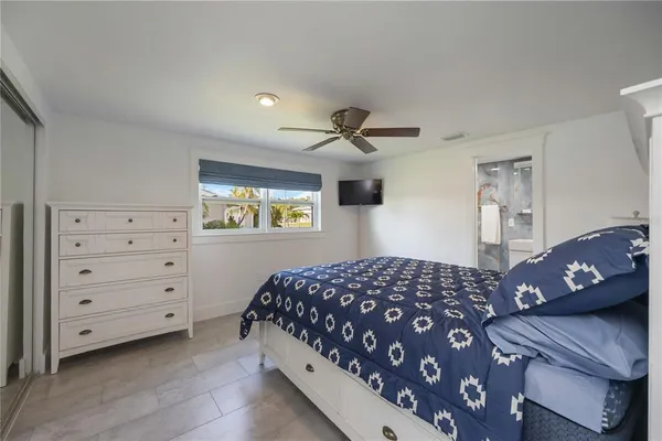 a bedroom with a bed a couch and a dresser