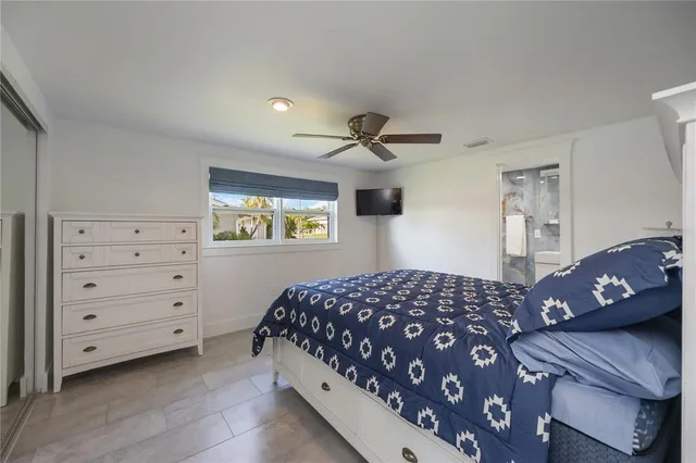 a bedroom with a bed a couch and a dresser