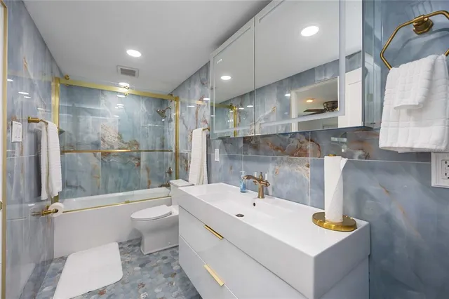 a bedroom with two beds and painting on the wall