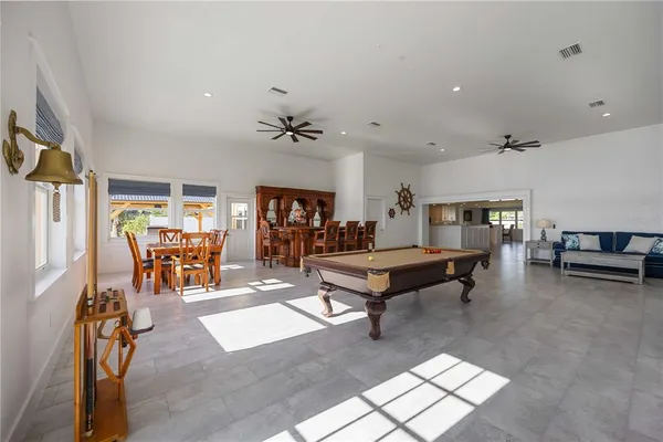 a living room with furniture a table and gym equipment