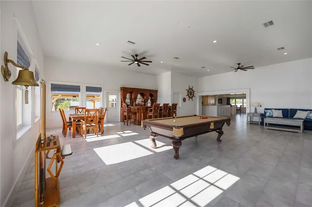 a living room with furniture a table and gym equipment
