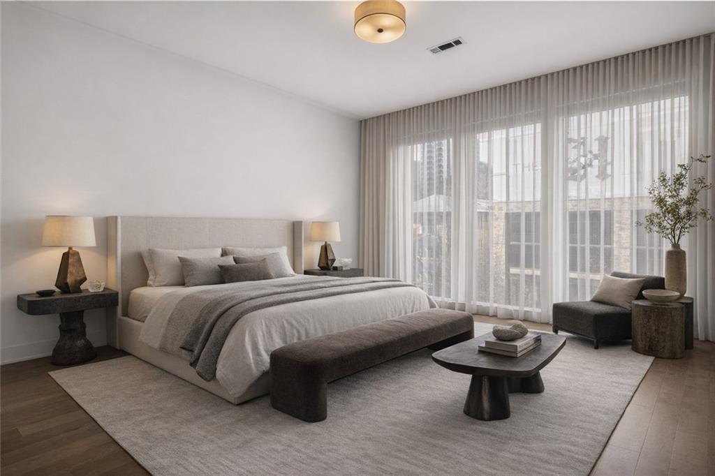 775 Juniper Street Northeast, Unit 413 Atlanta, GA 30308 - Photo 14 of 47 a spacious bedroom with a bed and large windows