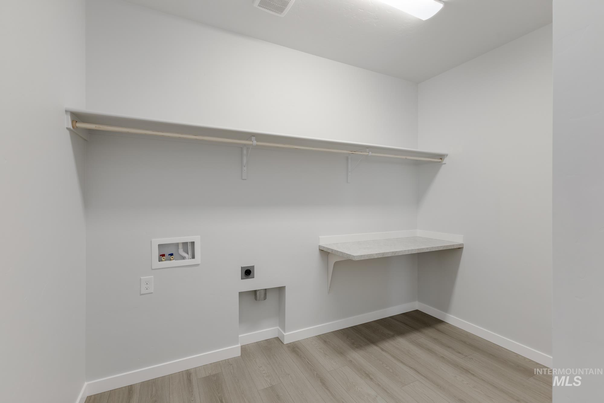 13638 Redway Court Caldwell, ID 83607 - Photo 16 of 21 Laundry area with light wood-style floors, electric dryer hookup, and washer hookup