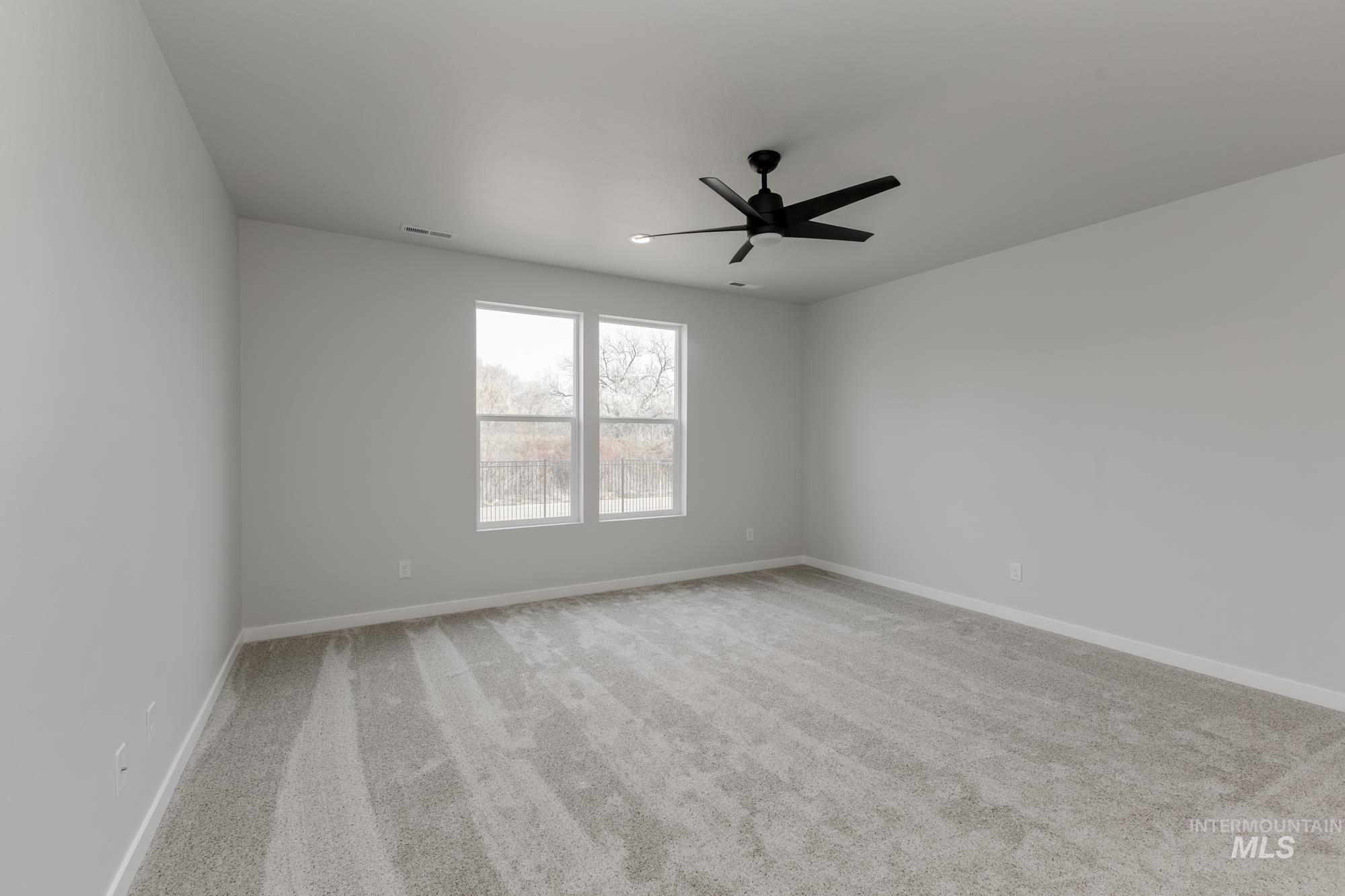 13638 Redway Court Caldwell, ID 83607 - Photo 17 of 21 Spare room with light colored carpet and a ceiling fan
