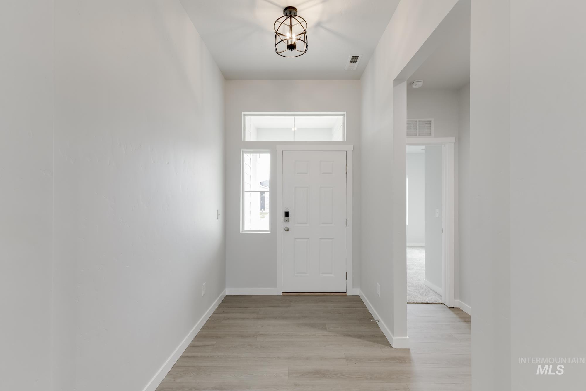 13638 Redway Court Caldwell, ID 83607 - Photo 2 of 21 Foyer entrance with light wood-style floors and baseboards
