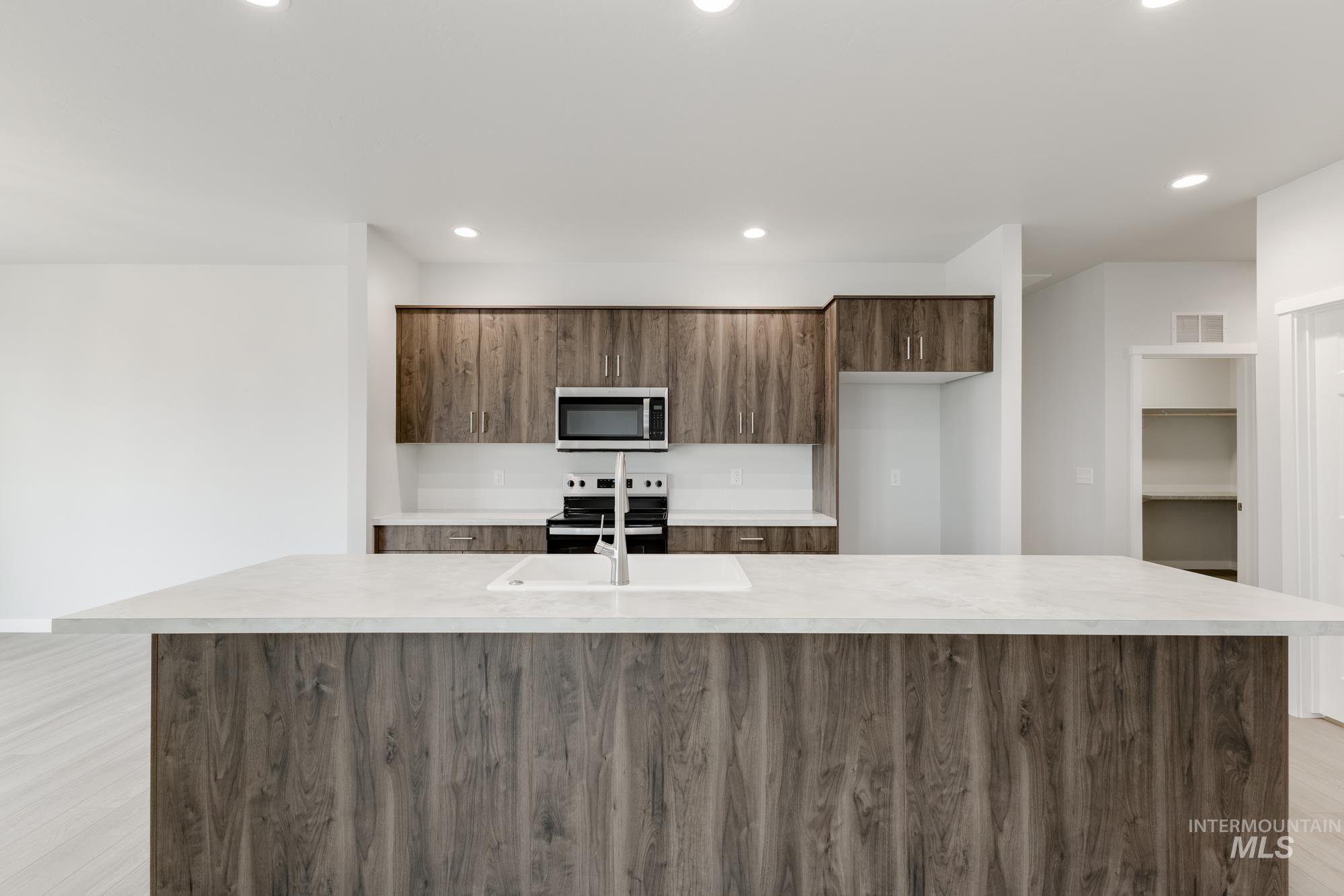 13638 Redway Court Caldwell, ID 83607 - Photo 3 of 21 Kitchen with a center island with sink, modern cabinets, stainless steel appliances, light wood-style flooring, and recessed lighting