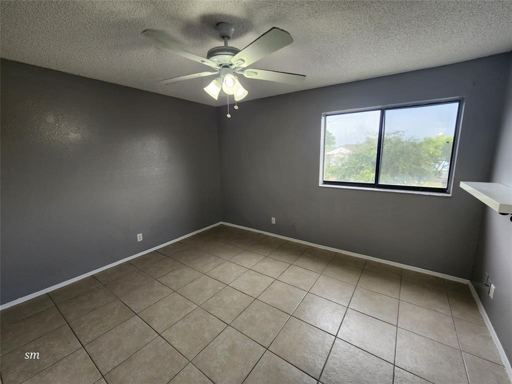 2866 South University Drive, Unit 5308 Davie, FL 33328 - Photo 12 of 26 en empty room with windows and chandelier fan