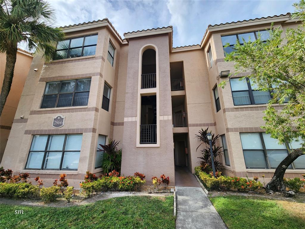 2866 South University Drive, Unit 5308 Davie, FL 33328 - Photo 26 of 26 front view of a house with a yard
