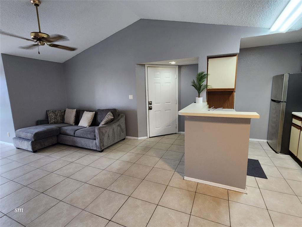 2866 South University Drive, Unit 5308 Davie, FL 33328 - Photo 3 of 26 a living room with a couch and a table