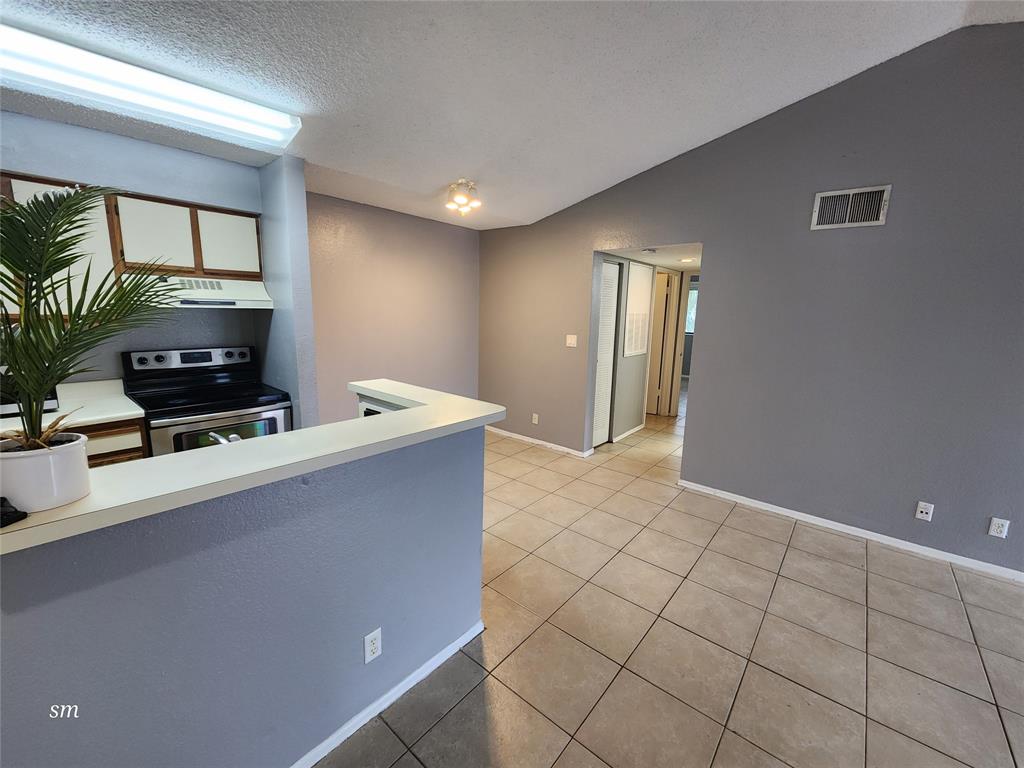 2866 South University Drive, Unit 5308 Davie, FL 33328 - Photo 6 of 26 a living room with furniture a flat screen tv and a window