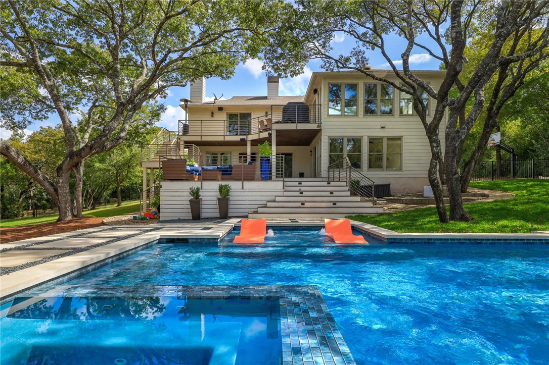 52 St Stephens School Road Austin, TX 78746 - Photo 1 of 1 a front view of a house with swimming pool and trees