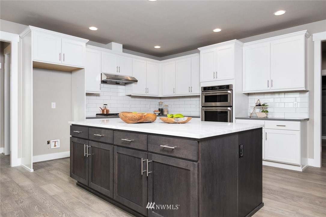 6505 Southeast 2nd Place Renton, WA 98059 - Photo 11 of 25 a kitchen with stainless steel appliances granite countertop a sink stove and refrigerator