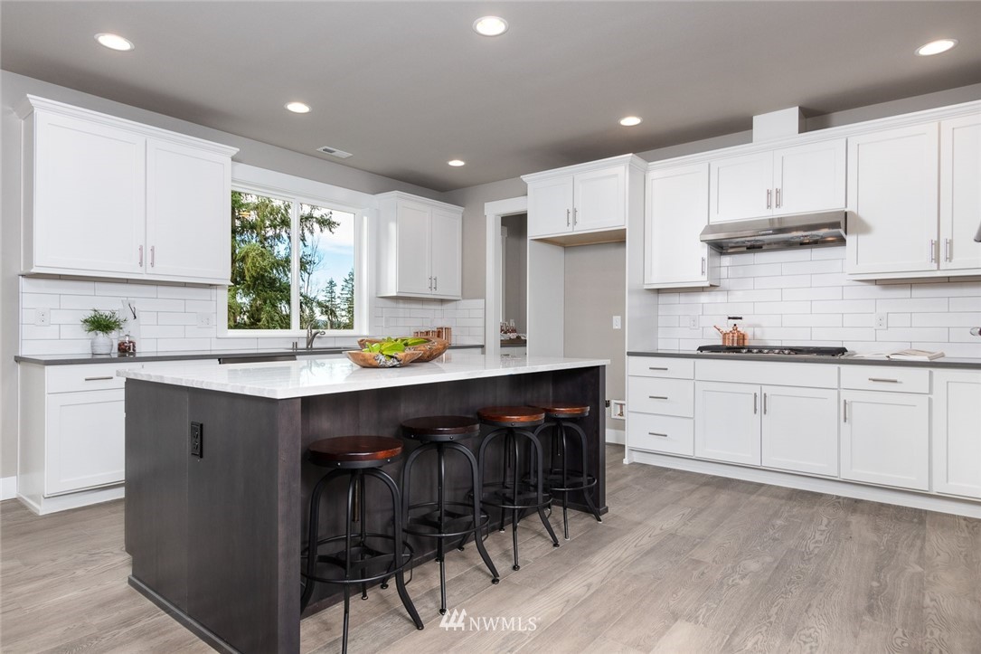 6505 Southeast 2nd Place Renton, WA 98059 - Photo 12 of 25 a kitchen with a sink white cabinets and stainless steel appliances