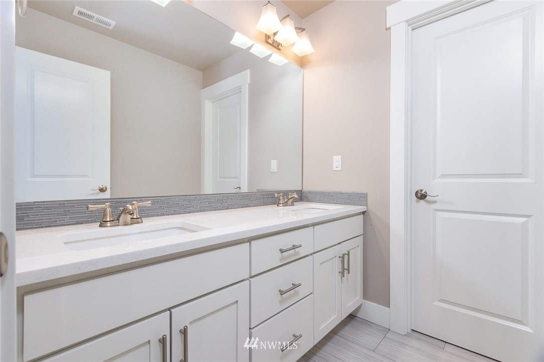 6505 Southeast 2nd Place Renton, WA 98059 - Photo 16 of 25 a bathroom with a double vanity sink and a mirror