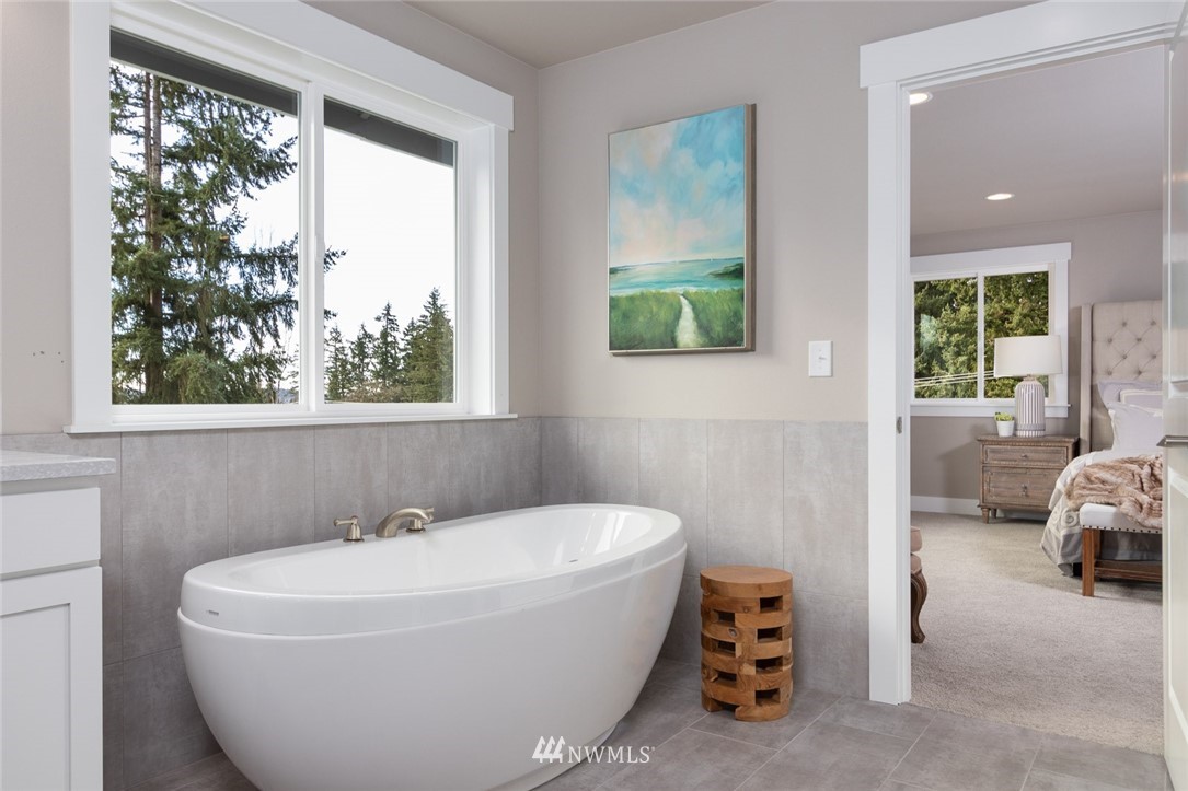 6505 Southeast 2nd Place Renton, WA 98059 - Photo 17 of 25 a white bath tub sitting in a bathroom next to a window