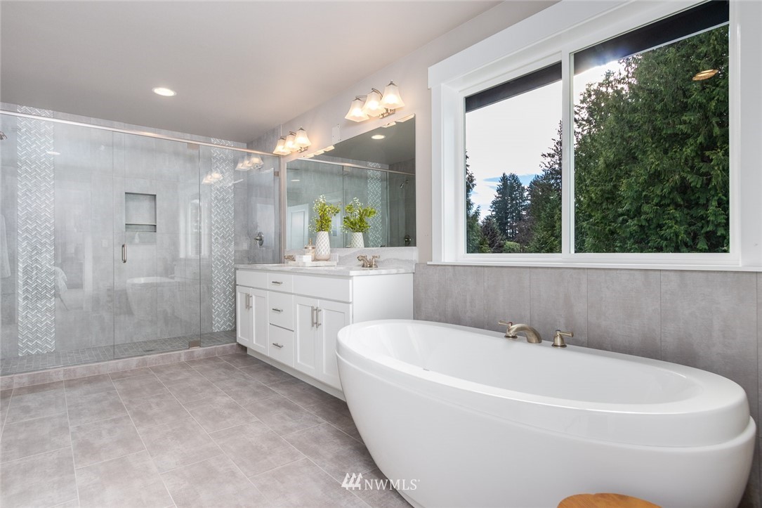 6505 Southeast 2nd Place Renton, WA 98059 - Photo 18 of 25 a white bath tub sitting in a bathroom and mirror