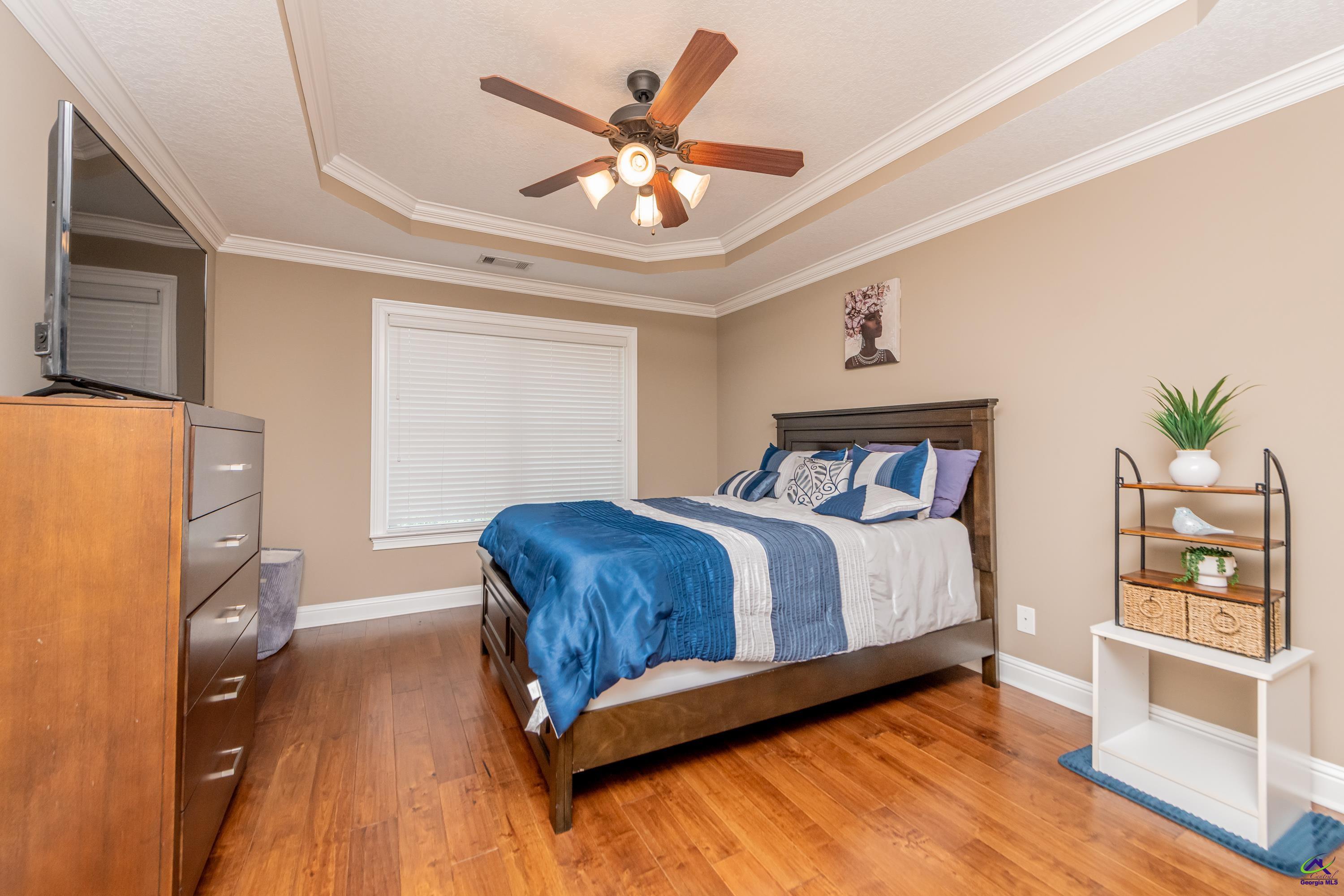 405 Old Bridge Road Warner Robins, GA 31088 - Photo 45 of 58 a bedroom with a bed and a chandelier