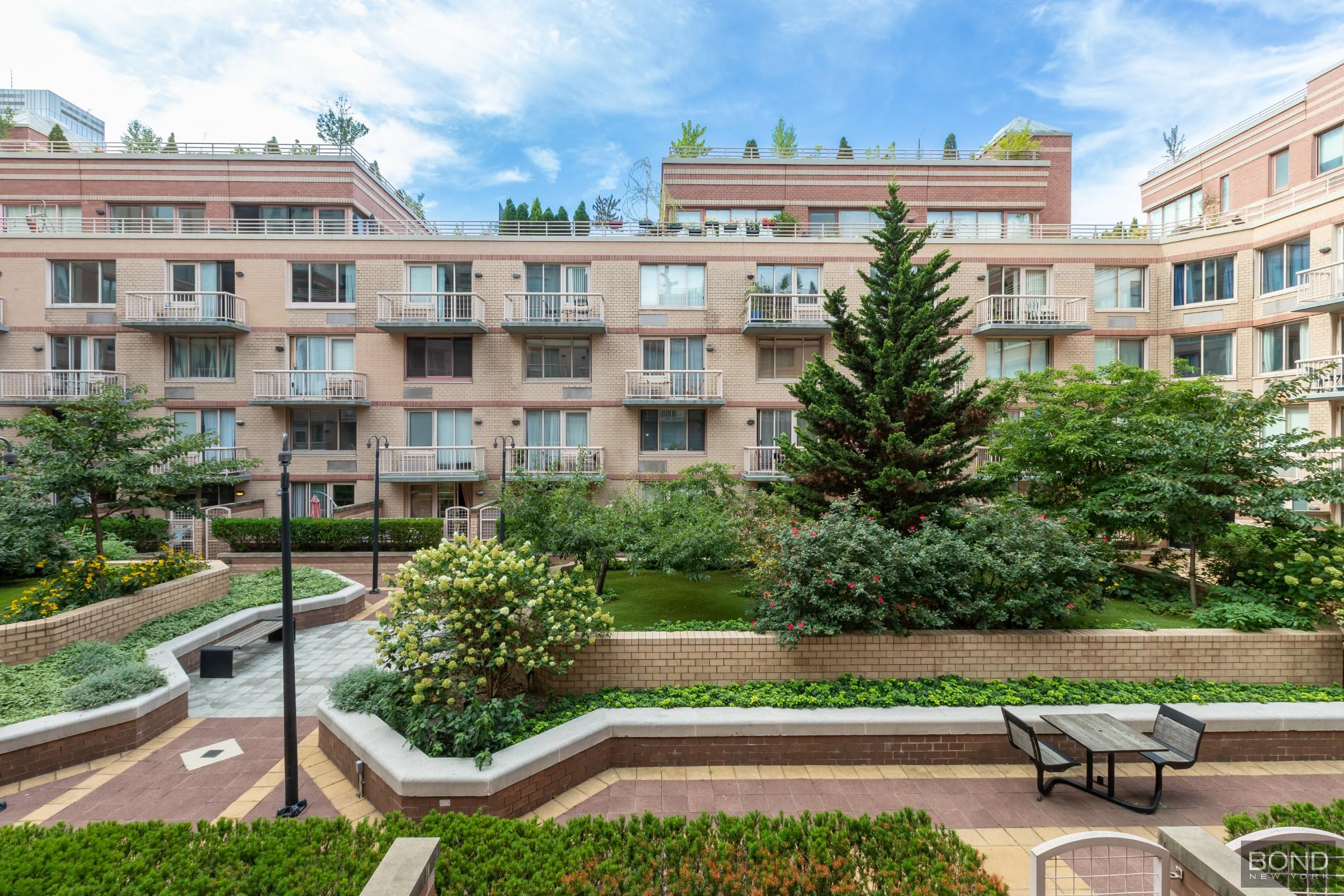 393 West 49th Street, Unit 3OO Manhattan, NY 10019 - Photo 3 of 16 a view of multiple houses with a yard