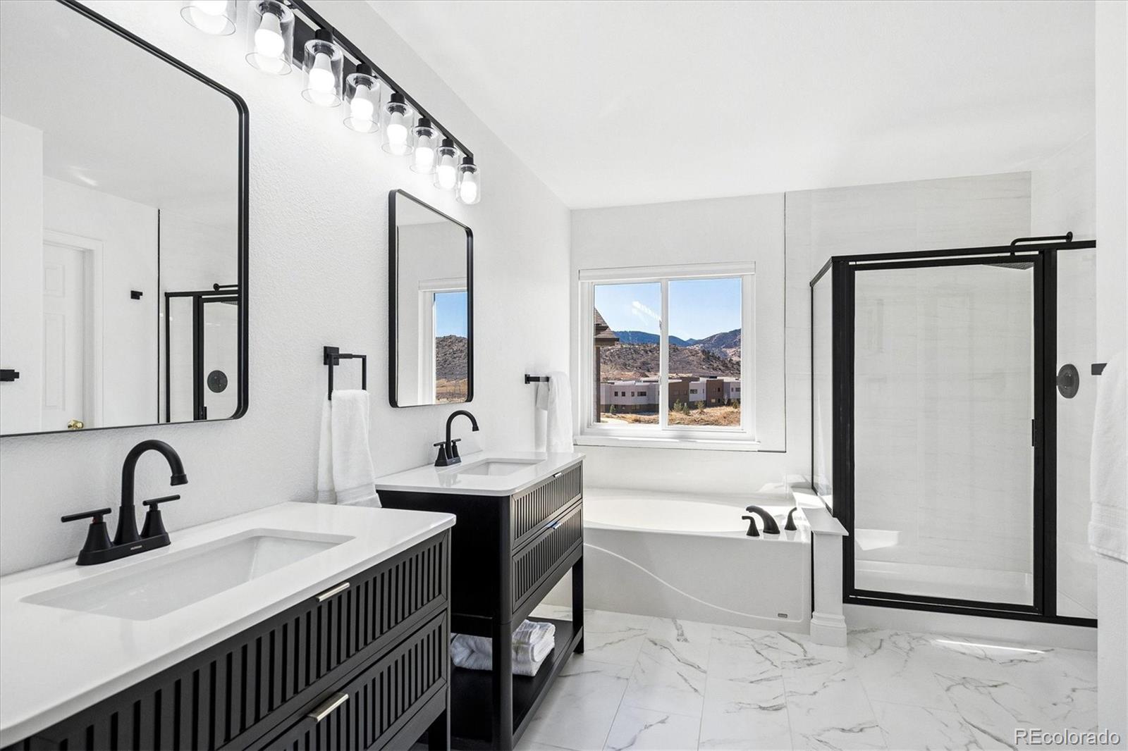 4143 South Deframe Court Morrison, CO 80465 - Photo 32 of 48 a bathroom with a sink and a mirror