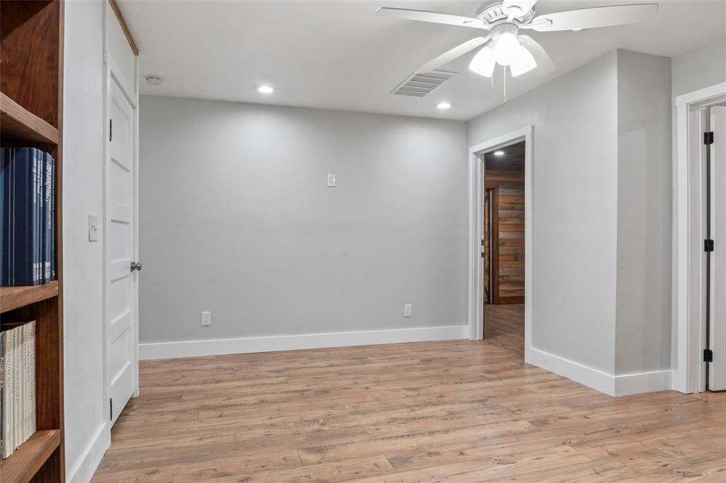 7949 North Fm 373 Road Muenster, TX 76252 - Photo 31 of 38 an empty room with wooden floor and fan