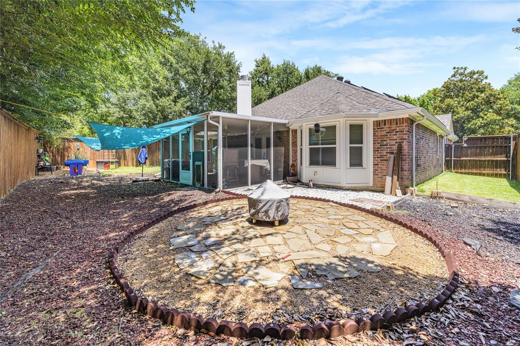 2813 Ridgemere Drive Flower Mound, TX 75028 - Photo 16 of 18 a front view of a house with a yard patio and outdoor seating