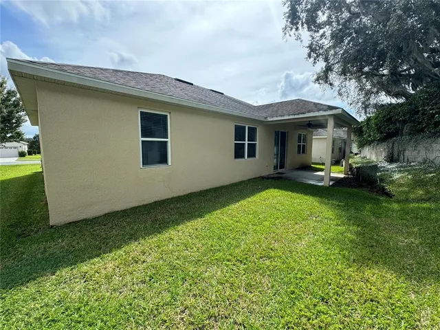 a yellow house with trees in front of it
