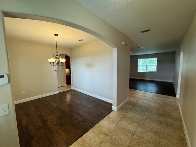 an empty room with windows and entrance