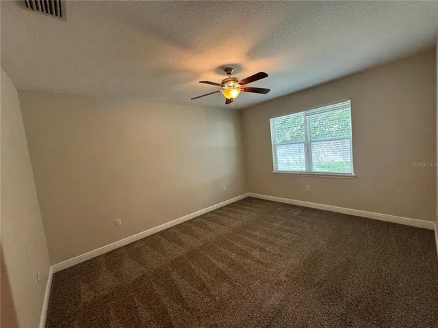 a spacious bathroom with a granite countertop sink a mirror and a vanity