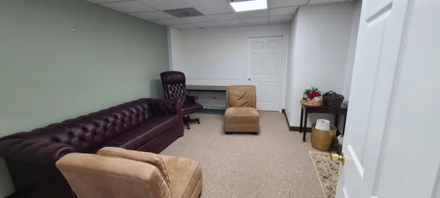 a living room with furniture and a lamp