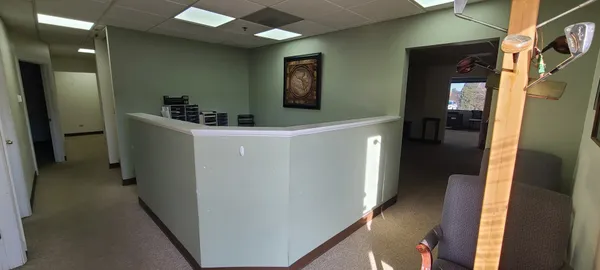 a hallway with cabinets and wooden floor