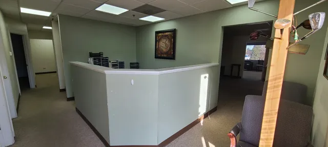 a hallway with cabinets and wooden floor