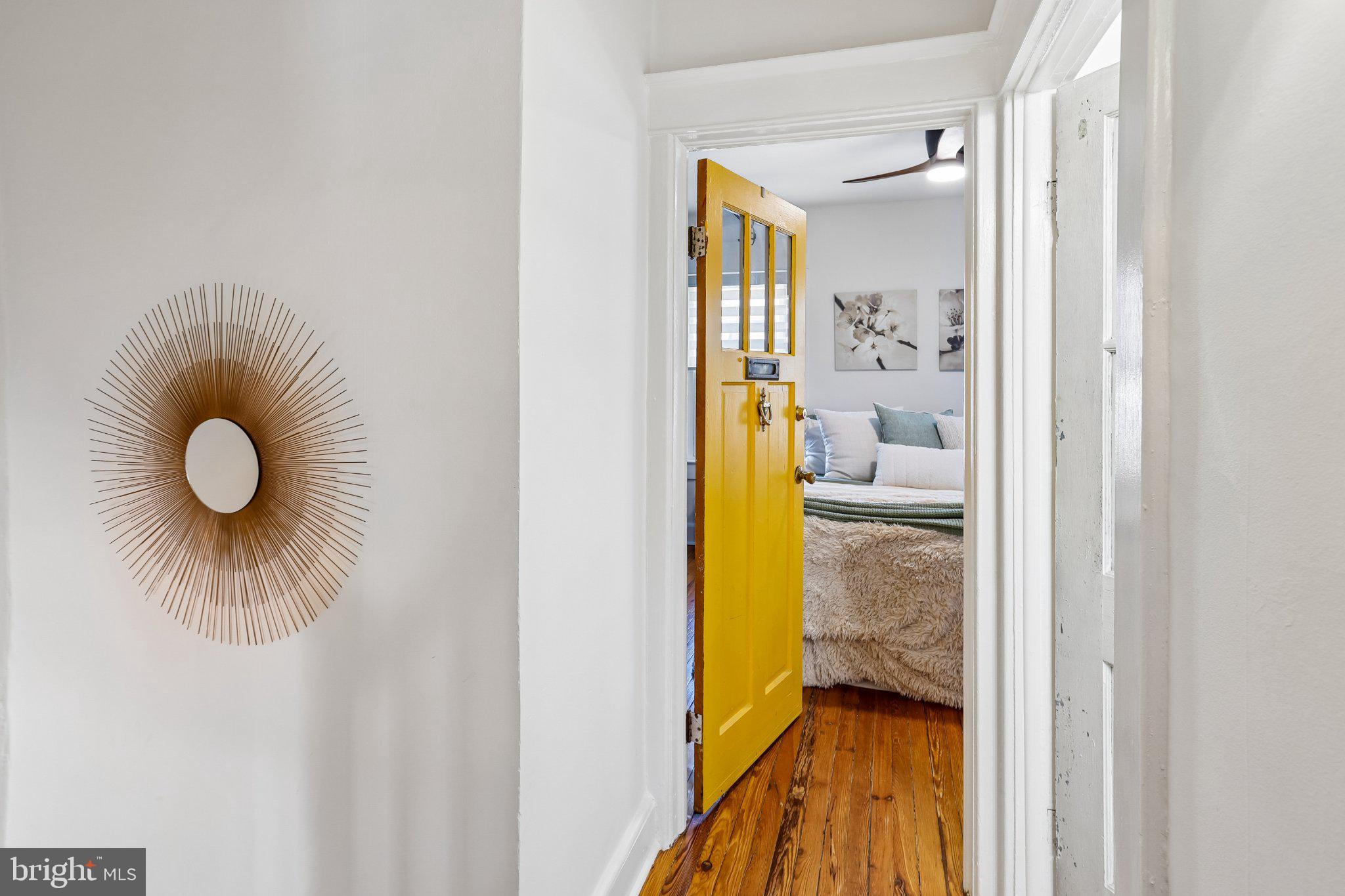 3124 Chestnut Avenue Baltimore, MD 21211 - Photo 16 of 25 Charming bedroom with vibrant yellow door.