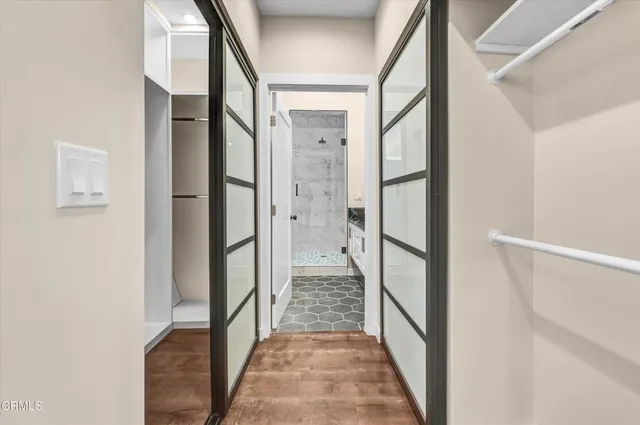 a bathroom with a granite countertop sink a mirror and shower